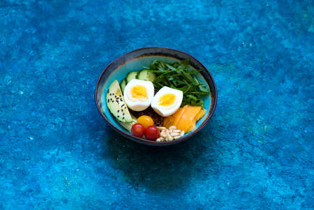 Bowl Healthy salad with avocado, egg and fresh vegetables. Ð¡lean eating, top view. Healthy food concept.の写真素材