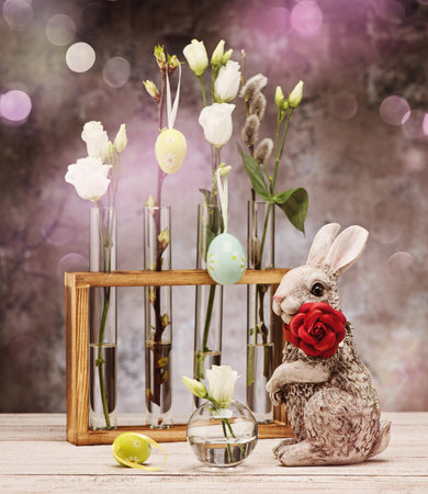 Easter holiday card. Easter bunny with flowers and eggsの写真素材