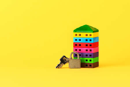 House symbol and keys on a yellow background. Cottage construction concept, layout and architectural plan, moving to a new house, ready business. Space for text.の写真素材