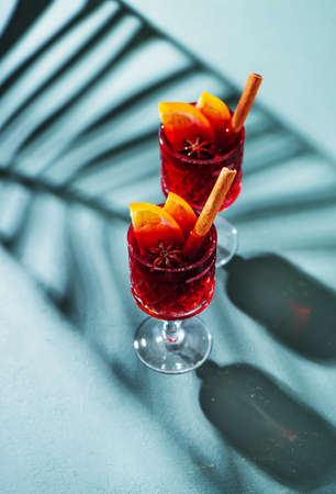 Hot mulled wine with fruits and spices, top view. Christmas and holidays festive backgroundの写真素材