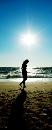 Girl walking on beach. Conceptual scene.の写真素材