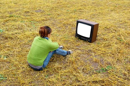 Girl watch TV on the yellow meadow. Element of designの写真素材