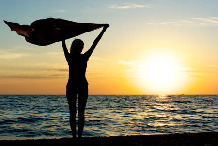 Girl with kerchief on the sunset. Relax scene. の写真素材