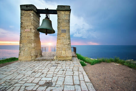 Big bell on sea shore. Nature composition.