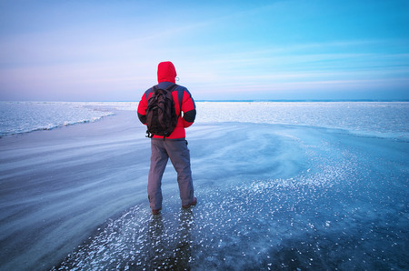 Man and winter ice. Nature composition. 