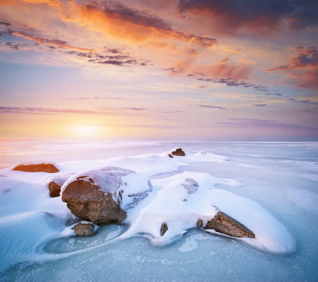 Stone on ice. Winter landscape.の写真素材