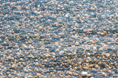 Multiexposure of stones on the beach and sea waves surface.の写真素材