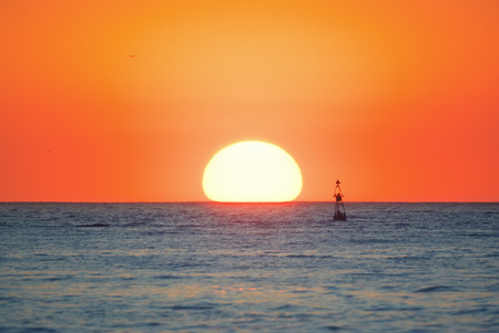 Big sun on the sea. Sunset nature composition.