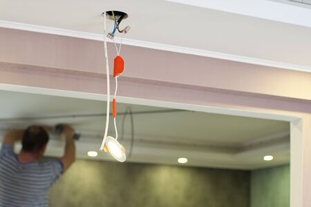 Repair of ceiling lamp. Working scene.の写真素材