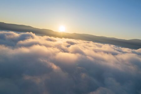 Fly in sky. Nature view above the clouds at sunrise. 