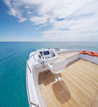 View from yacht flybridge open deck on the calm sea water at day. Modern and luxury equipped with...