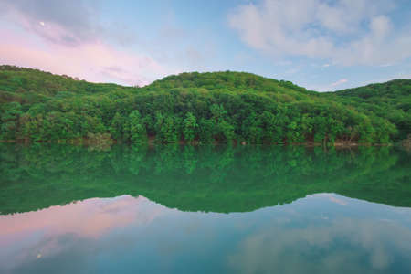 Lake in mountain during the sunset. Nature landscape.の写真素材
