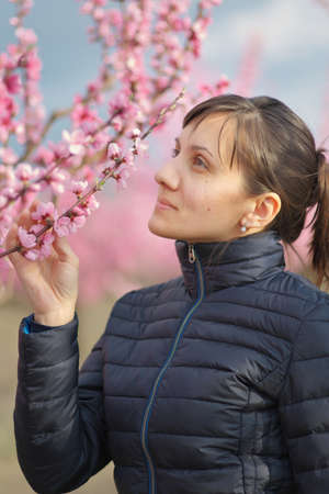 Young woman portrait in peach garden.の写真素材