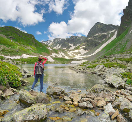 Landscape of Caucasus Dukka lake in mountain. Person and nature. Travel and relax scene.