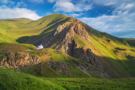 House in mountain green valley and morning sunshine. nature landscape.の写真素材