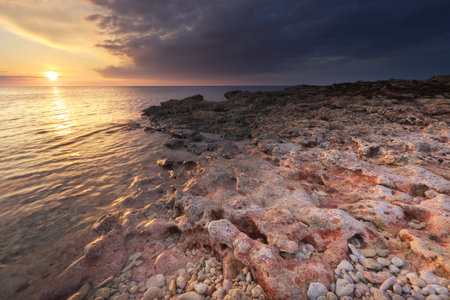 Beautiful sunset on the sea shore. Nature seascape composition.の写真素材