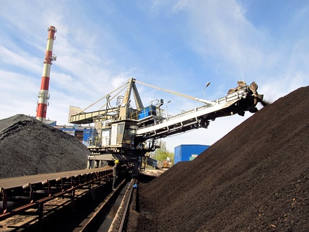 Stacker with a heap of coal next to the plantの写真素材