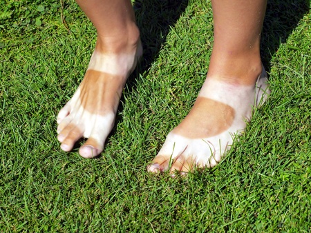 woman legs walking in sandals in the sun tanned in a characteristic wayの写真素材