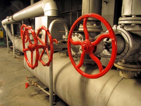 Pipes and valves with red knobs for hot watterの写真素材