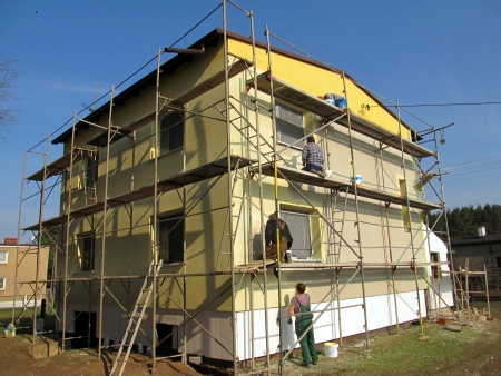 The construction works. Priming the facade of the building before applying the plaster,の写真素材