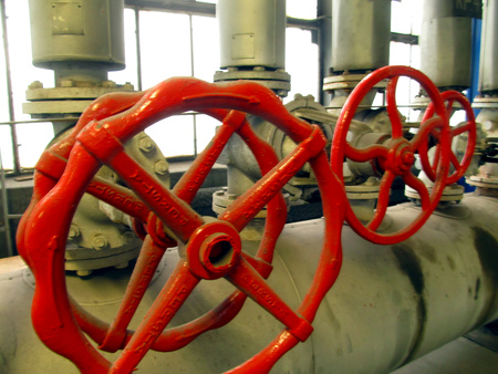 Pipes and valves with red knobs for hot waterの写真素材