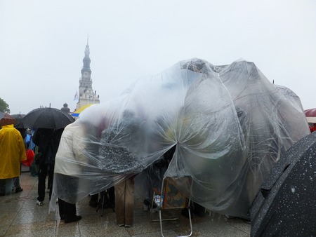 community under one protective film - XIX National Sleep Renewal of the Holy Spirit in the pouring rain before the peak of Jasna Gora in Czestochowa, Poland, 17 may 2014のeditorial素材