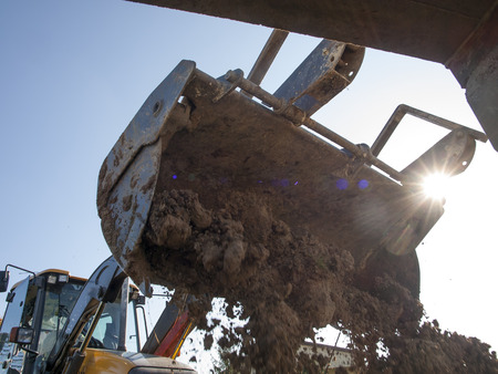 The machine, wheel loader during backfilling around the foundation of the building on the site