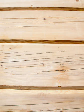 fragment of a wall from wooden logs as backgroundの写真素材