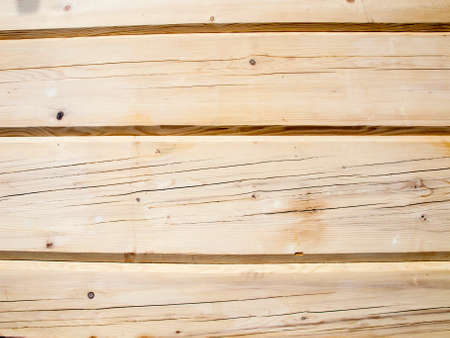 fragment of a wall from wooden logs as backgroundの写真素材