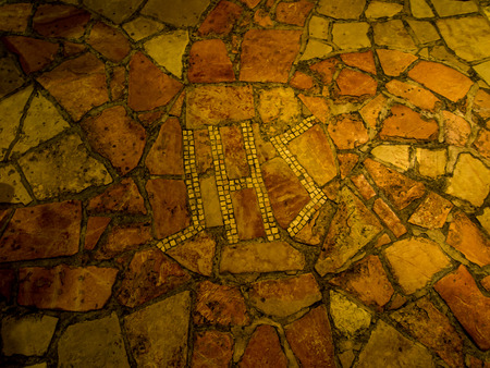 BETHLEHEM, Israel, July 12, 2015: The city of Bethlehem.Fragment floor with the inscription IHS in the grotto of St. Jerome in the area of the church of St. Catherine and close to the Basilica of the Nativity of the birth of Jesus Christのeditorial素材