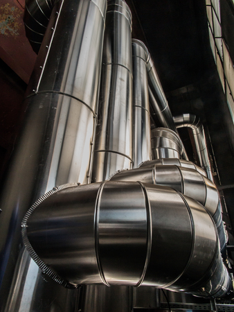 pipes with hot water, insulated with mineral wool covered with aluminum sheet