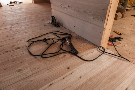 a fragment of a wooden house under construction and toolsの写真素材