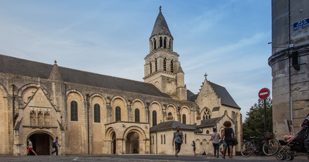 Poitiers, France - September 12, 2016: Very old church Notre Dame la Grande in Poitiers, France, and hurry, unidentified people passing in a hurry nextのeditorial素材