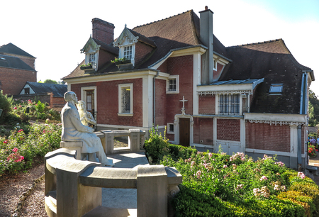 House in Lisieux, where she lived St. Therese of the Child Jesus before joining Carmel. The garden statue of St. Teresa and St. Louis Martin her father.のeditorial素材