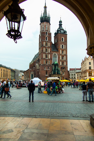 Krakow, Poland - October 2, 2016:  Main market square of Cracow in soft light of sunrise, vie of St. Mary cathedral. Krakow, Rynek Glowny, Bazylika Mariackaのeditorial素材