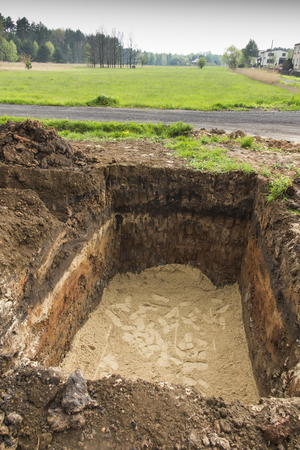 digging and leveling the bottom of the backyard septic tank outflowの写真素材