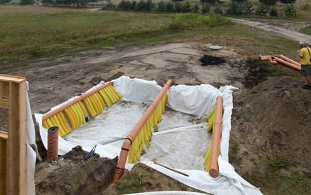 Building a ground heat exchanger to heat up the air in winter and cool down in summerの写真素材
