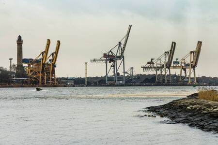 Lighthouse building and lifting equipment at the entrance to the port of Swinoujscie on the Baltic Sea in Polandのeditorial素材