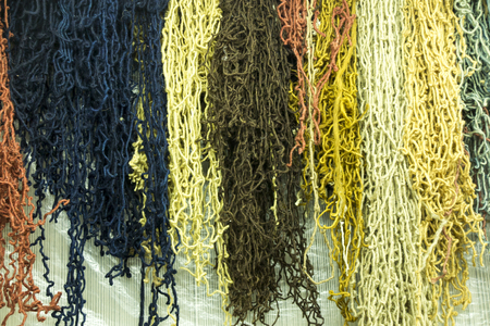 differently colored thick fibers for making carpets as a backgroundの写真素材
