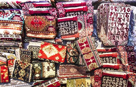 colorful fabrics and other folk products at a roadside stall with traditional Armenian colors and patterns as a backgroundの写真素材