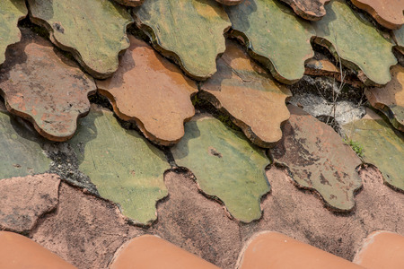 old roof tiles arranged on the roof as a background