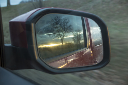 autumn sunset in the rearview mirror of the carの写真素材