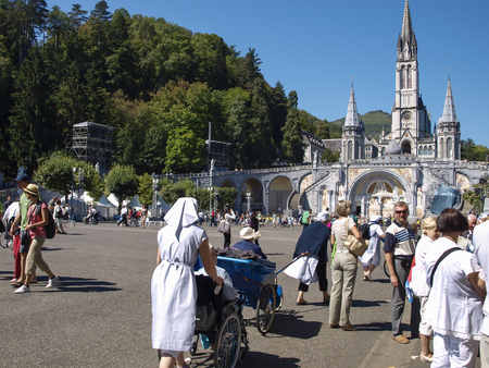 Lourdes, France, August 11, 2011: Groups of people walking for healing to the shrine of Our Lady in Lourds, Franceのeditorial素材