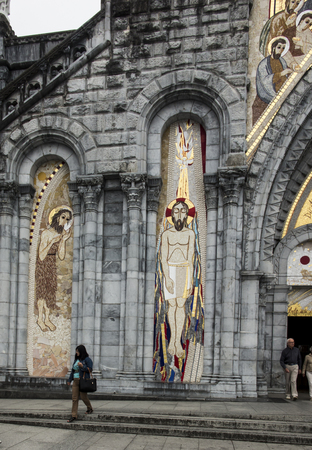 Lourdes, France, 24 June 2019: Mosaic of the studio of Marko Rupnik on the wall in front of the entrance to the Rosary Basilica in Lourdes.のeditorial素材