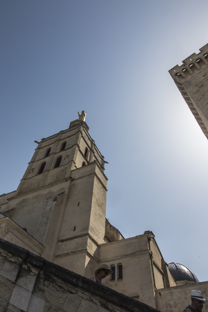 Avignon cathedral (Cathedral of Our Lady of Doms) next to Papal palace (Palais des Papes) under blue sky in Avignon, Franceのeditorial素材