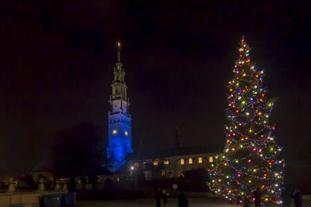 The tower in the sanctuary at Jasna GÃ³ra in Czestochowa in Poland illuminated in blue on the day of Saint Mary the Holy Mother of God in the evening on the first day New Year 2020.の写真素材