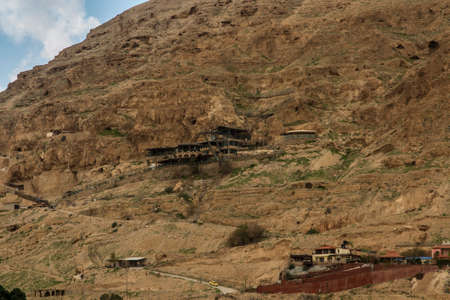 Mountainside of Temptations of Jesus with tourist and other facilities in Jericho, Israel,...