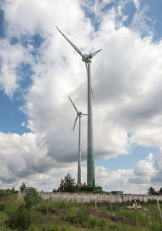 Two large windmills producing ecological electricity from wind