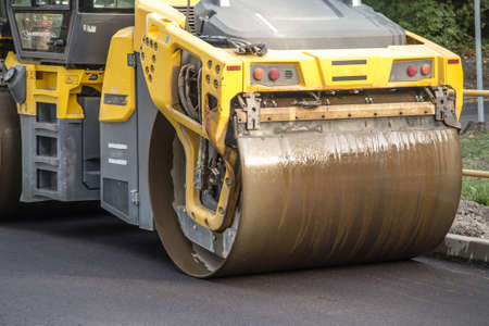 road roller smoothing the top layer of asphalt