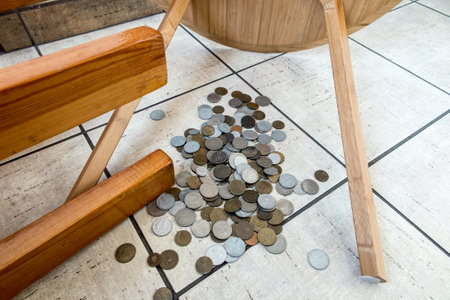Tables overturned and coins scattered across the floor.の写真素材